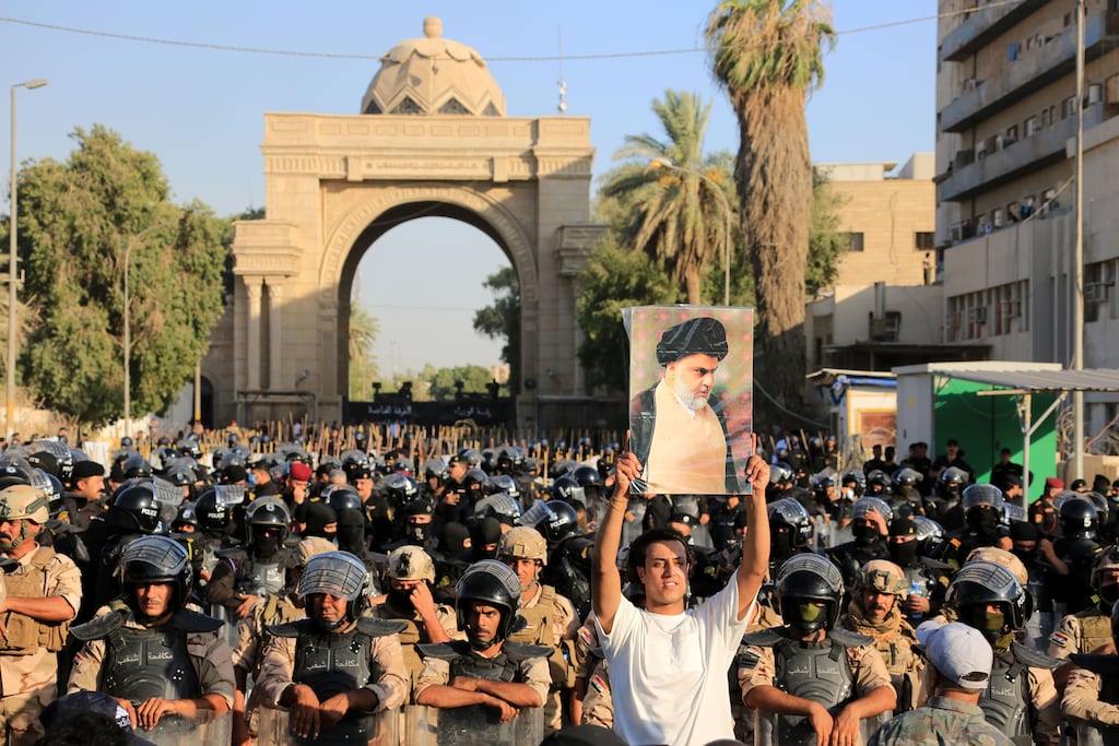Iraqi security forces stand guard as supporters of Shia cleric Muqtada al-Sadr, head of the Sadrist movement, attempt to storm the 'Green Zone' in central Baghdad. Photograph: Ahmed Jalil/EPA