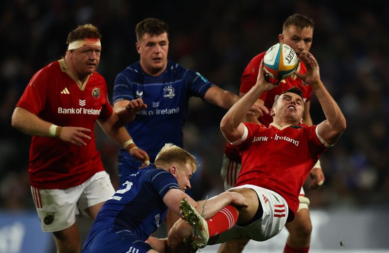 Leinster's Jamie Osborne tackles Tom Farrell of Munster. Photograph: Tom Maher/Inpho