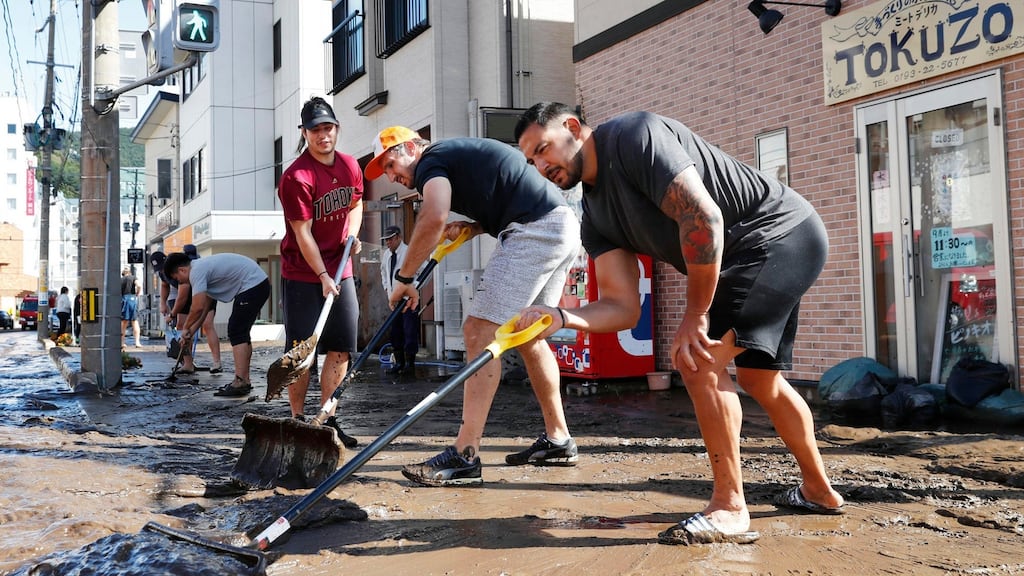 Canadian rugby players volunteer to clean a road in Kamaishi, Iwate, following the cancellation of their Rugby World Cup match against Namibia due to Typhoon Hagibis. Photograph: Kyodo News via AP