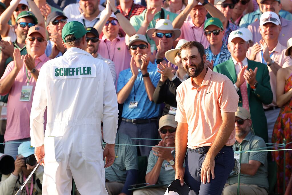 Scottie Scheffler and caddie Ted Scott celebrate on the 18th green after victory in the 2024 Masters at Augusta National. Photograph: Jamie Squire/Getty Images