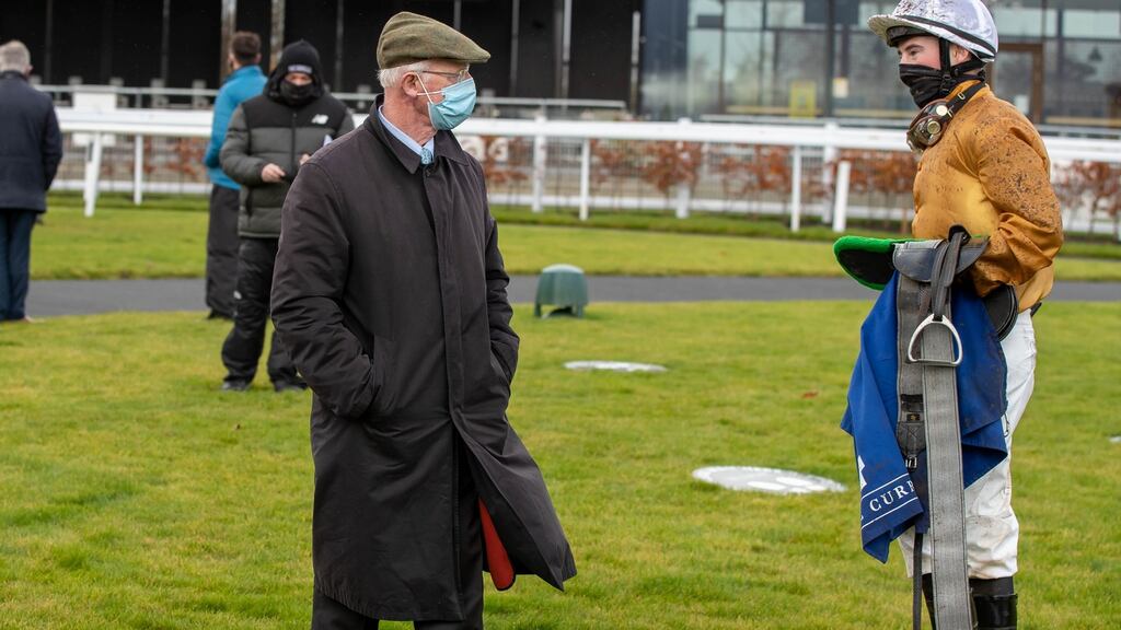 John Oxx talks to jockey Gavin Ryan at the Curragh on Monday, where he ran his final horses as a trainer. Photograph: Morgan Treacy/Inpho
