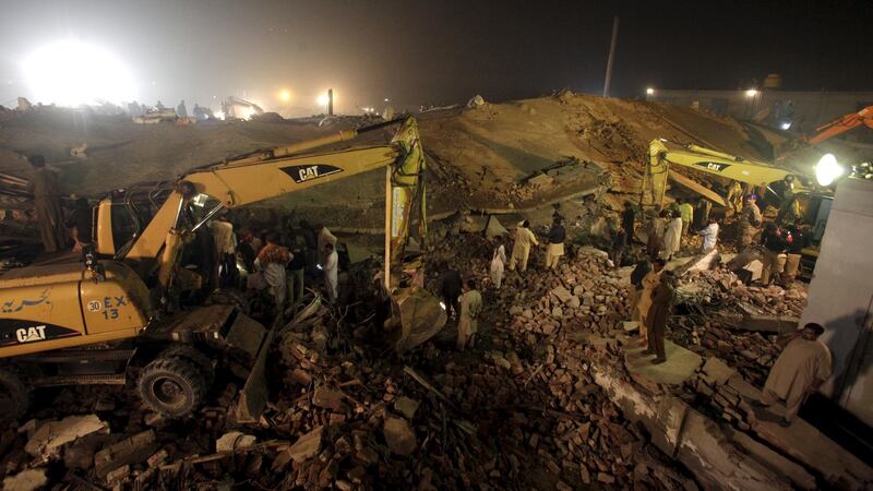 Rescue workers search for survivors after a factory collapsed near the eastern city of Lahore, Pakistan, November 4th, 2015. At least 18 people were killed and up to 150 trapped on Wednesday when a factory collapsed.  Photograph: Mohsin Raza/Reuters