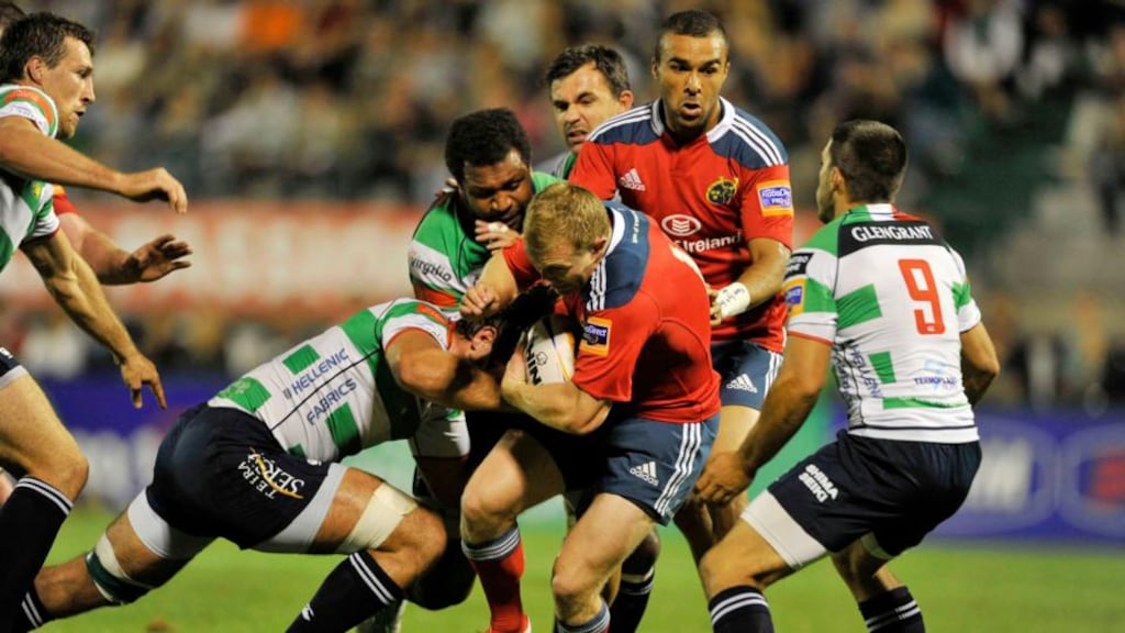 Munster’s Keith Earls is tackled as Simon Zebo looks on in Treviso. Photograph: Elena Barbini/Inpho