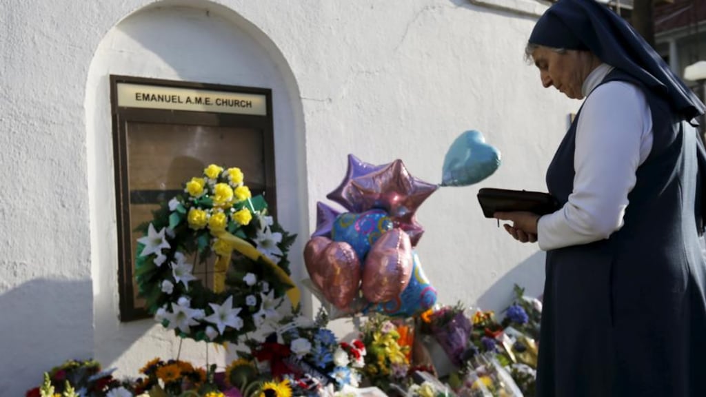 Sister Mary Thecla, from the Daughters of St Paul, prays outside the Emanuel African Methodist Episcopal Church in Charleston two days after a mass shooting left nine dead during a bible study at the church. Photograph: Brian Snyder/Reuters