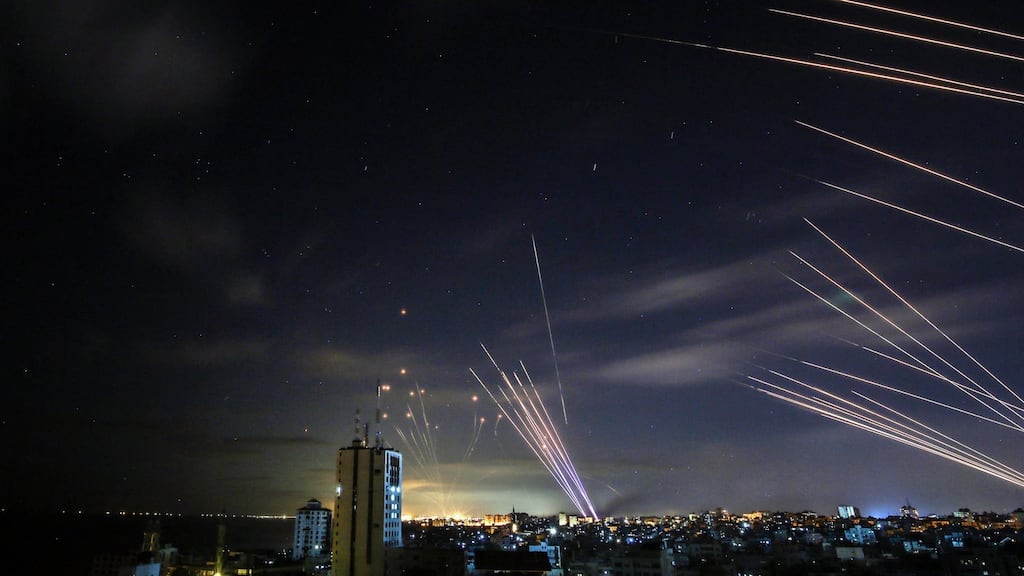 The Israeli Iron Dome missile defence system (left) intercepts rockets (right) fired by the Hamas movement towards southern Israel from Beit Lahia in the northern Gaza Strip, early on Sunday. Photograph: Anas Baba/AFP via Getty Images