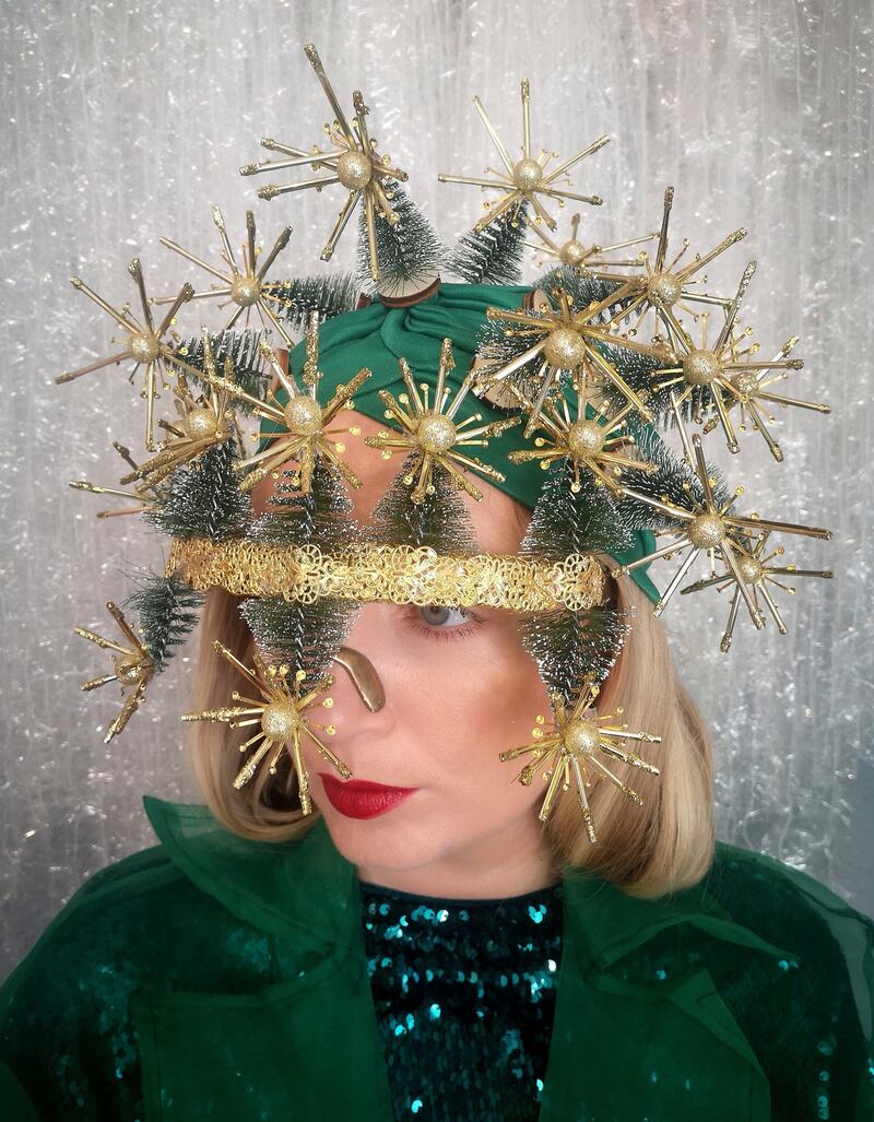 Angel – my granny gave me the porcelain angel with a green velvet dress and gold wings – this is my take on it using deconstructed visor shades and customising them with spray paint and covering them with filigree pieces from an old decoration. The hat has miniature trees which I customised with glitter foil stars. Modelled by Aisling Gibney