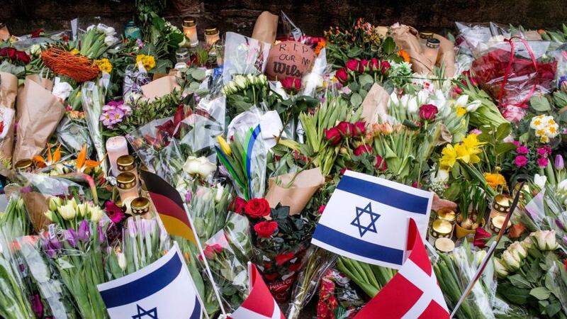 Floral tributes are placed at the site, where a Danish Jew was shot dead as he stood guard at a Jewish confirmation at the weekend, in front of the synagogue in Krystalgade, Copenhagen,. Photograph: Bax Lindhardt/Scanpix Denmark/Reuters