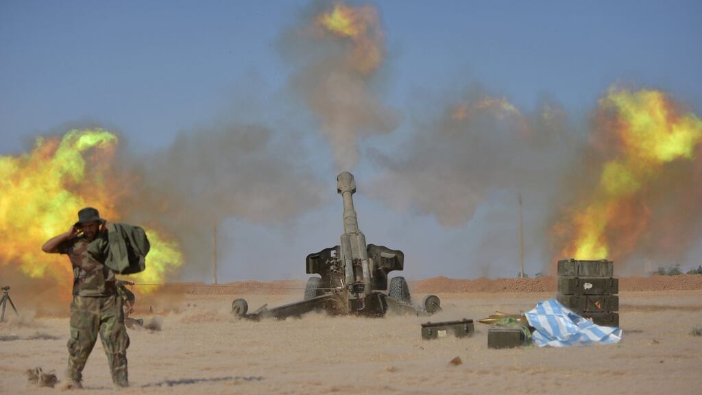 Popular Mobilization Forces (PMF) personnel fire artillery during clashes with Islamic State militants south of Mosul. Photograph: Stringer/Reuters