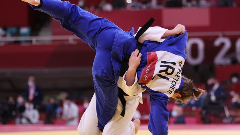 Ireland’s Megan Fletcher (blue) in action against Michaela Pollerees of Austria. Photo: James Crombie/Inpho