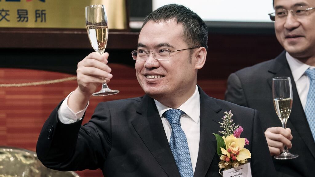 Wu Wenhui, co-chief executive officer of China Literature, celebrates as the online bookshop owned by Tencent jumped 100 per cent on its Hong Kong Stock Exchange debut.  Photograph: Anthony Kwan/Bloomberg