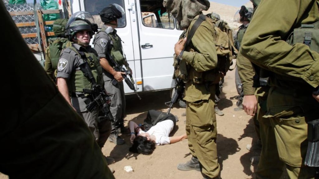 French diplomat Marion Castaing on the ground after Israeli soldiers carried her out of her truck containing emergency aid in the West Bank herding community of Khirbet al-Makhul in the Jordan Valley yesterday. Photograph: Abed Omar Qusini/Reuters.