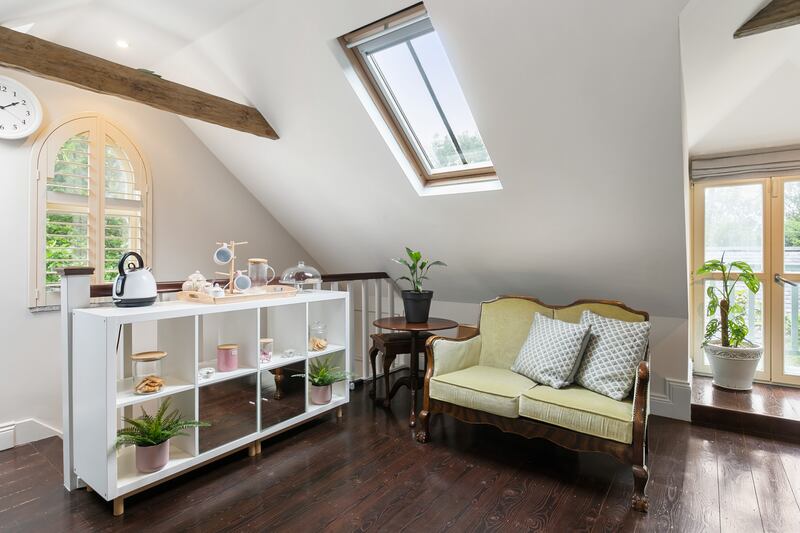 The attic has been converted into a home office/livingroom
