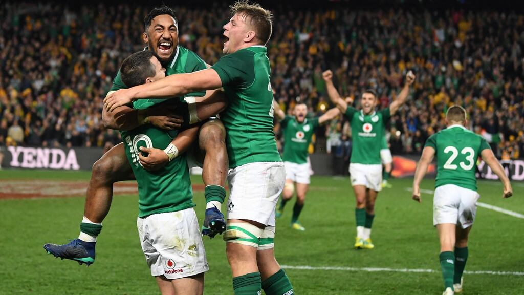 Ireland’s Bundee Aki jumps on teammate Johnny Sexton with Jordi Murphy as they celebrate winning the third Test against Australia in Sydney. Photo: David Moir/EPA
