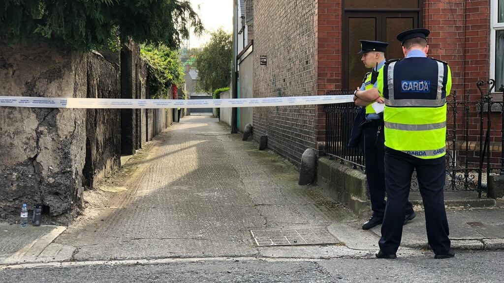 Gardaí at the  scene at  a laneway off Madison Road in Kilmainham, Dublin 8 where a man was found dead. Photograph: Ronan McGreevy