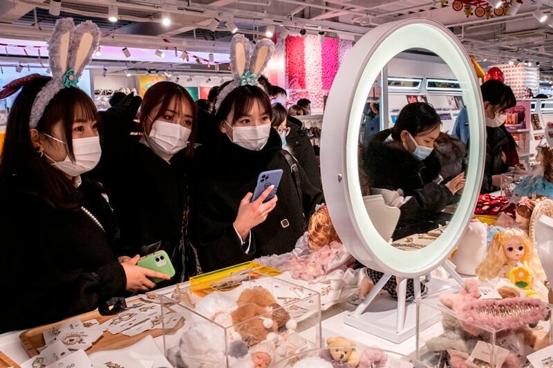 Masked shoppers check out dolls and accessories at a store in Wuhan, on December 31st. Photograph: Gilles Sabrie/The NewYork Times