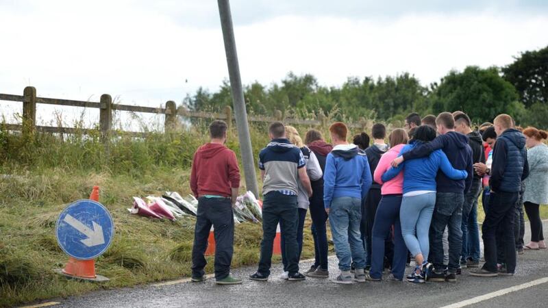 Young people stand and support each other at the crash scene on the Rathdowney to Abbeyleix Road, Co Laois where three people were killed. Photograph: Dara Mac Dónaill/The Irish Times