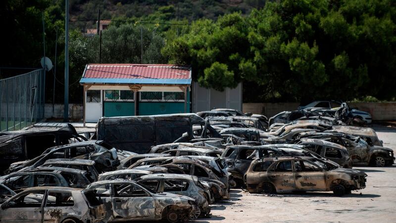 Burnt cars parked outside a football ground on Thursday at the village of Rafina, near Athens. Photograph:  Angelos Tzortzinis/AFP/Getty Images