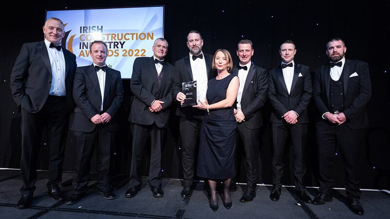 Collette Burns, awards judge, presents the COVID-19 Crisis Response Award to the Clancy Construction team.