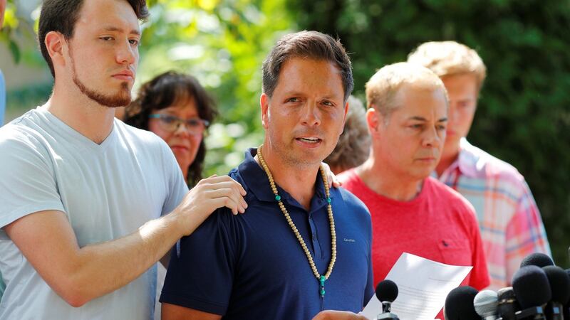 Don Damond is comforted by his son Zach Damond as he speaks to the media about his fiance, Justine Damond. Photograph: Adam Bettcher/Reuters