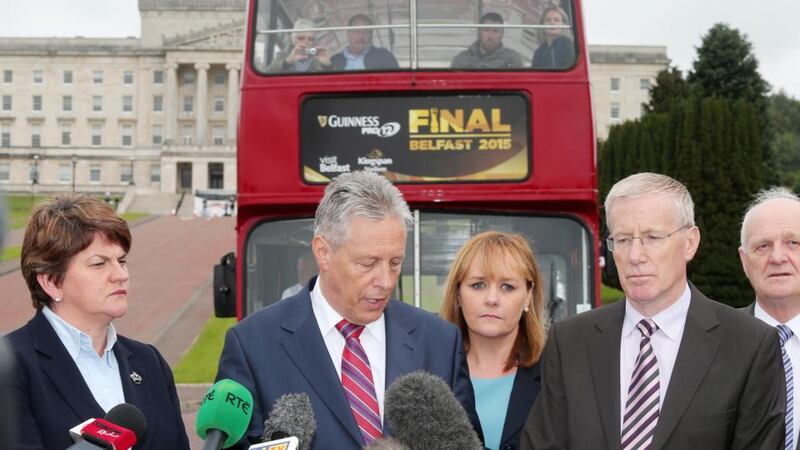 DUP leader and First Minister Peter Robinson along with party colleagues talk to the press at Carson’s statue in the Stormont estate in Belfast. Photograph: Jonathan Porter/PressEye