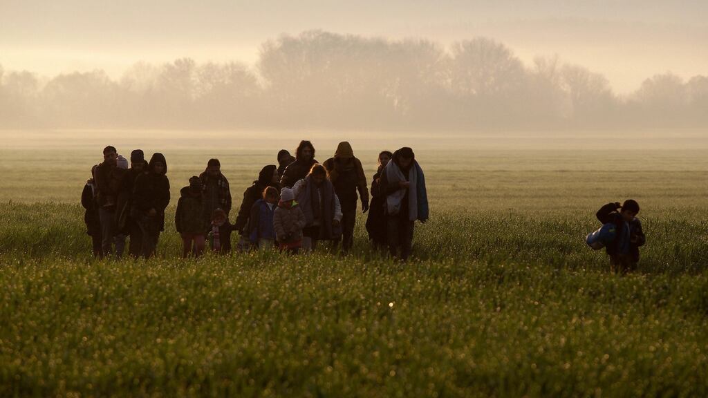 Refugees and migrants walk towards a makeshift camp near the village of Idomeni, Greece, on Monday. Photograph: Alexandros Avramidis/Reuters