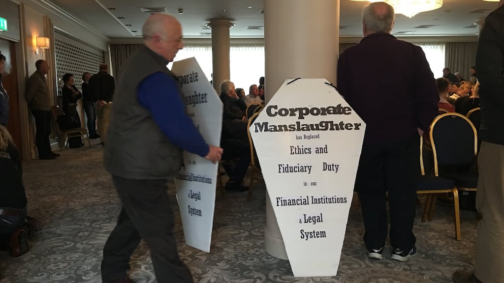 Frank Masterson placing his protest placards at the meeting in the Killeshin Hotel on Saturday. Photograph: Conor Pope/The Irish Times