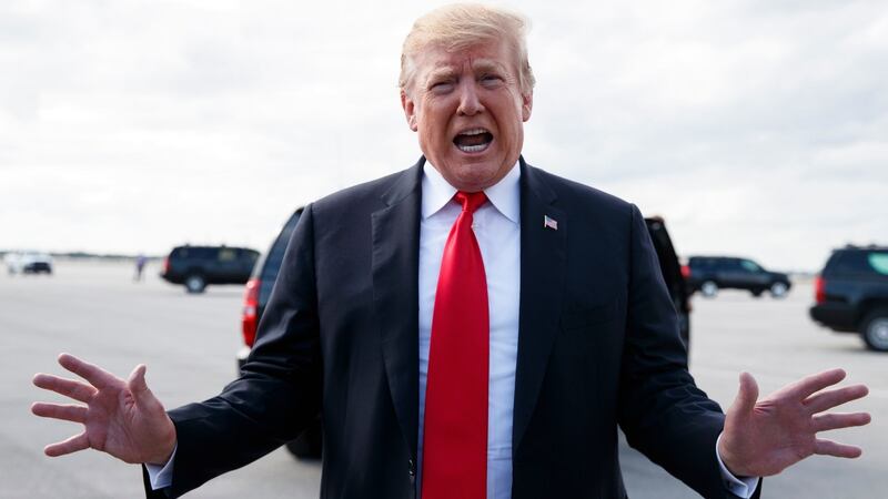 Donald Trump speaks to media before boarding Air Force One, at Palm Beach International Airport, Florida. Photograph: AP Photo/Carolyn Kaster
