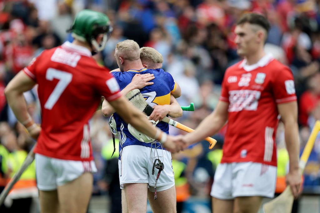 Tipperary's Eoghan Connolly celebrates with Oisín O'Donohue as their opponents accept the harsh reality of defeat in an All-Ireland final. Photograph: Laszlo Geczo/Inpho