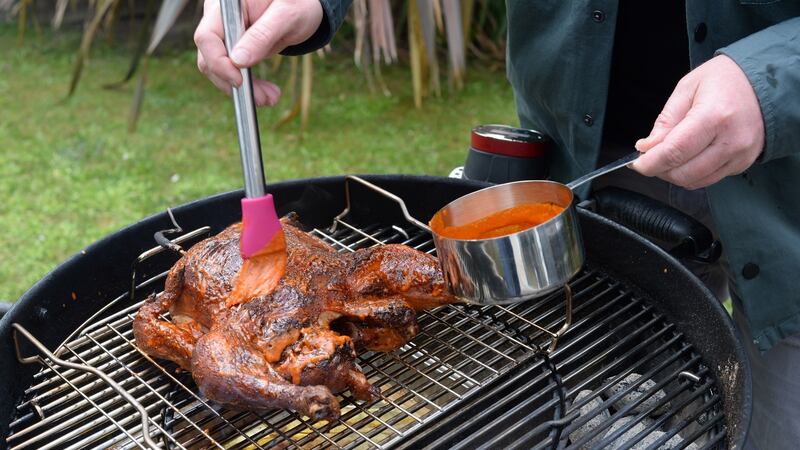 For the last few minutes of cooking, liberally brush the chicken with the piri-piri sauce. Photograph:  Dara Mac Donaill