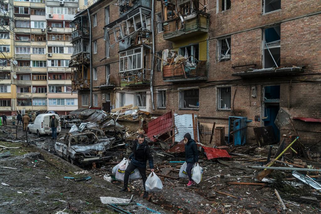 People salvage their belongings from a building that was struck by a Russian missile in Vyshhorod, Ukraine. Photograph: Brendan Hoffman/The New York Times