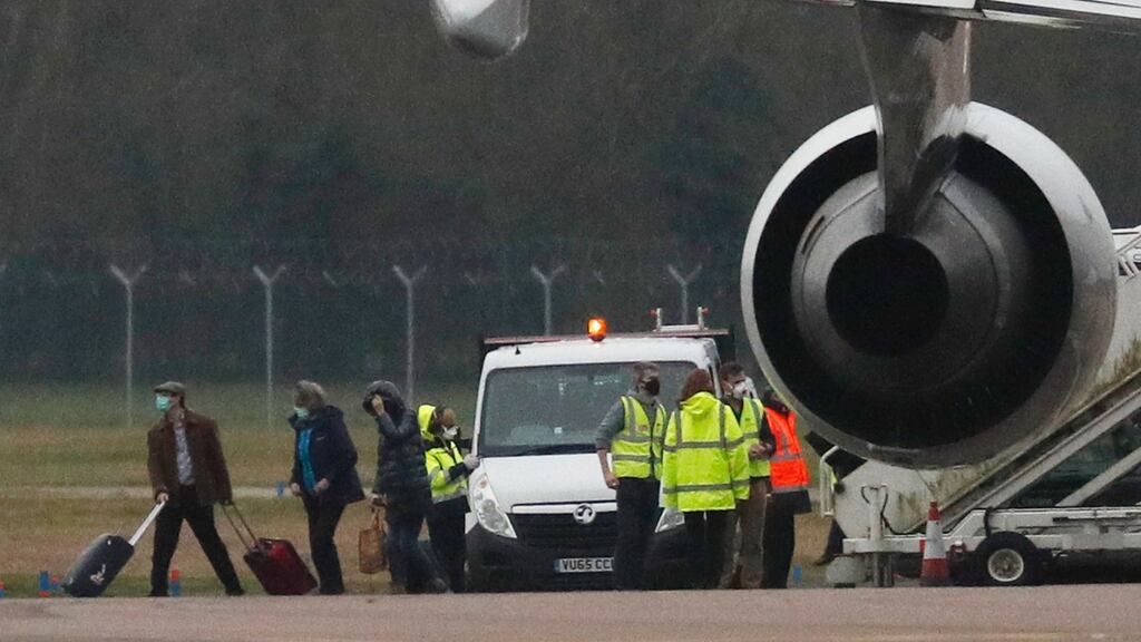British nationals evacuated from Wuhan in China are helped by personnel as they disembark at the Royal Air Force station in Carterton, west of London, on Friday. Photograph: Adrian Dennis/AFP via Getty Images