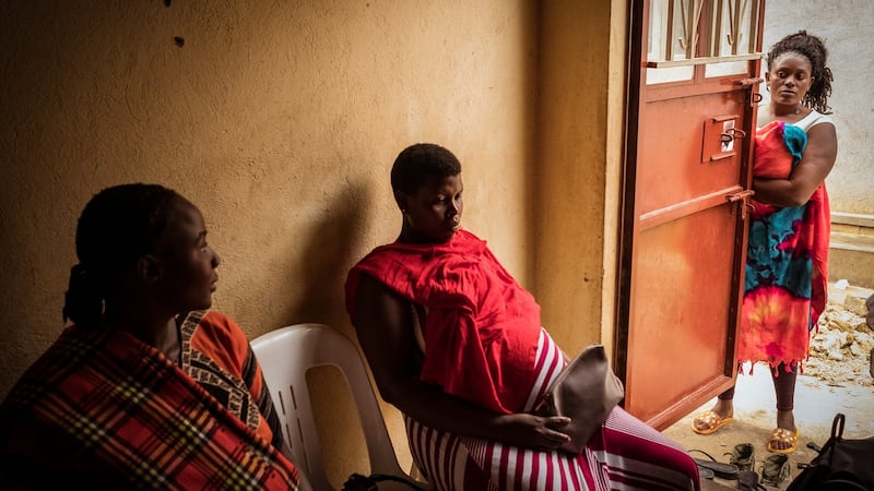 Nalule Hamirah, nine months pregnant with her second child, and Haddijjah Nabweteme, eight months pregnant with her fourth, speak to friends as they await consultation in Ruth Nakimera’s clinic in Kabaale, Entebbe. Photograph: Christopher Hopkins