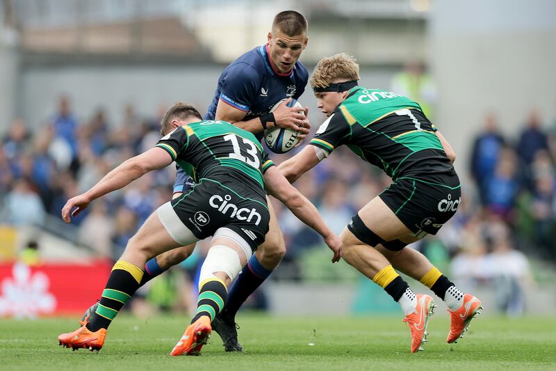 Leinster's Sam Prendergast is tackled by Fraser Dingwall and Henry Pollock of the Northampton Saints. Photograph: Laszlo Geczo/Inpho