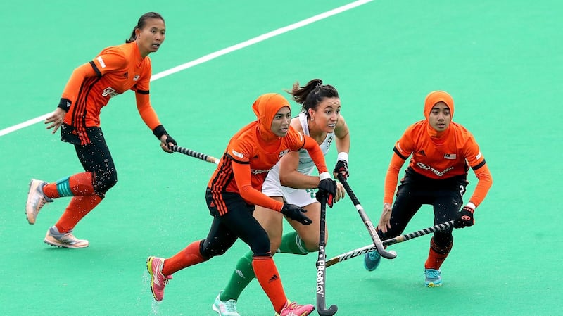 Malaysia’s Hasliza Ali Noor and Nuraini Rashid tackle Anna O’Flanagan. Photograph: Bryan Keane/Inpho