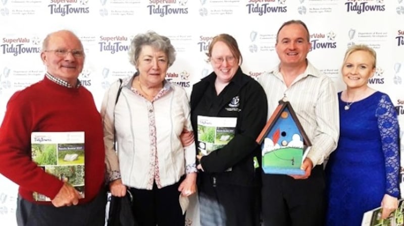 Emyvale Tidy Towns displaying their Waters & Communities Award, along with Carol Lambe (second left) from Monaghan County Council.
