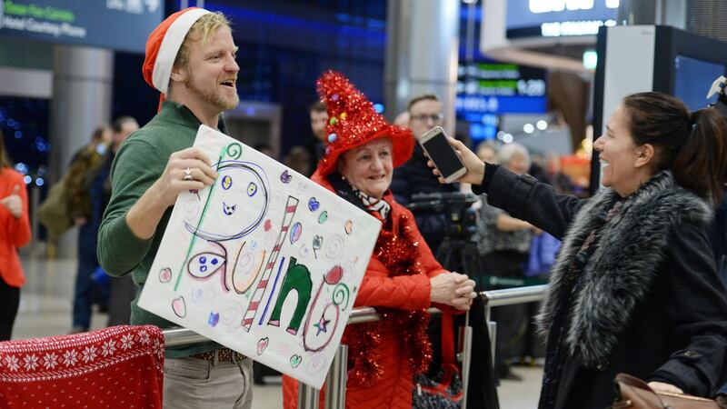Nik Quaife welcoming Pauline Turley a friend and colleague back from New York at Dublin Airport. Photograph: Alan Betson / The Irish Times