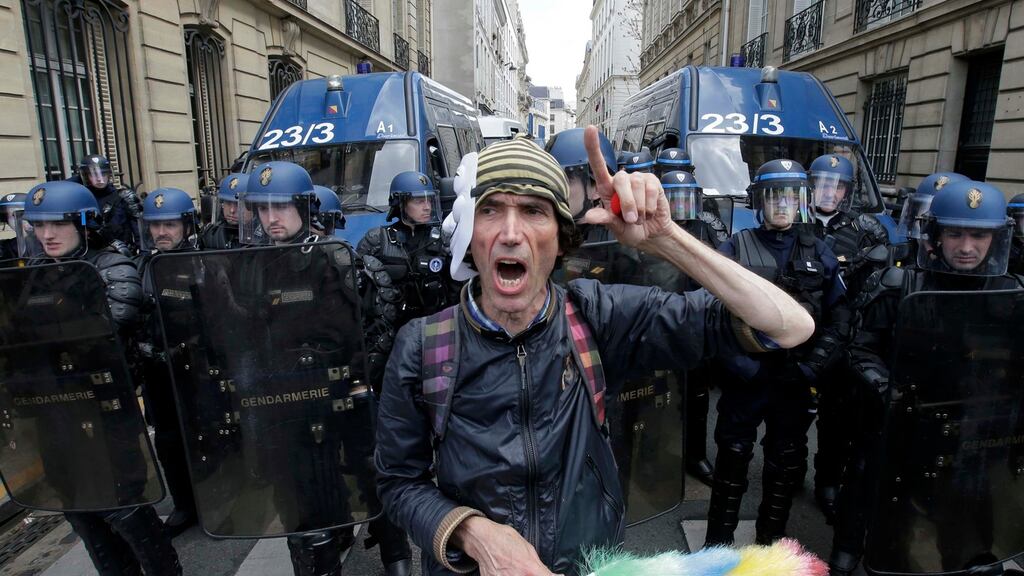 An activist shouts slogans in front of French gendarmes during a demonstration in Paris yesterday against the labour law proposal. Photograph: Jacky Naegelen/Reuters