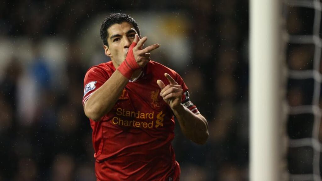 Liverpool’s Luis Suarez celebrates scoring his sides’ fourth goal during the Barclays Premier League match at White Hart Lane yesterday.