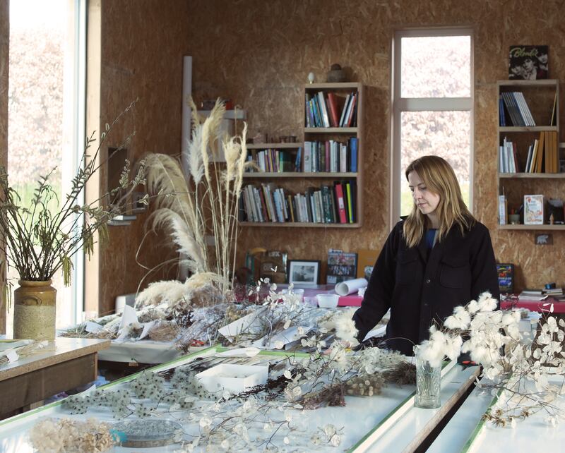 Sasha Sykes at work on one of the panels of her new five-panel folding screen