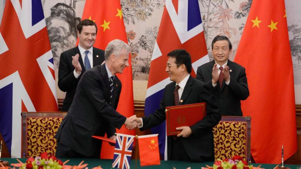 Britain’s chancellor of the exchequer George Osborne (back left) watches with Chinese vice premier Ma Kai (backright) as Paul Deighton, commercial secretary shakes hands with Xu Yongsheng, deputy director of China’s National Energy Adminstration, during a signing ceremony in Beijing today. Photograph: Kota Endo/Pool