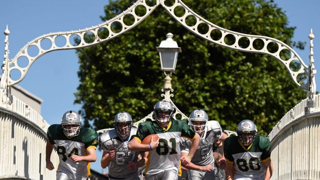 Simon Greene, Alan McDonagh, Neil Lynch, Eoin Hallissey and Chris Kane on the Ha’penny Bridge, Dublin, to publicise the game between Penn State and University of Central Florida at Croke Park. Photograph: Stephen McCarthy/Sportsfile