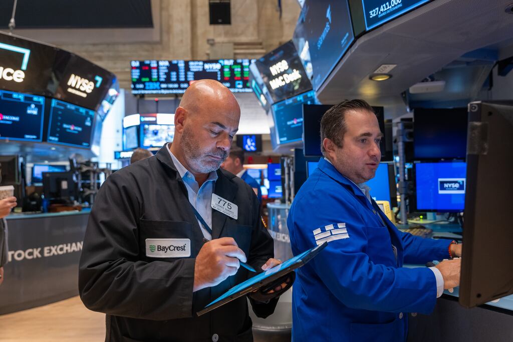 Traders work on the floor of the New York Stock Exchange: US markets were on course for their best weekly performance this year. Photograph: Spencer Platt/Getty Images