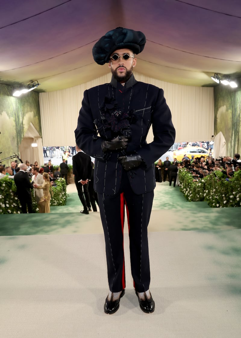 Bad Bunny wore a navy Maison Margiela tux with a fabric floral lapel. Photograph: Kevin Mazur/MG24/Getty Images for The Met Museum/Vogue