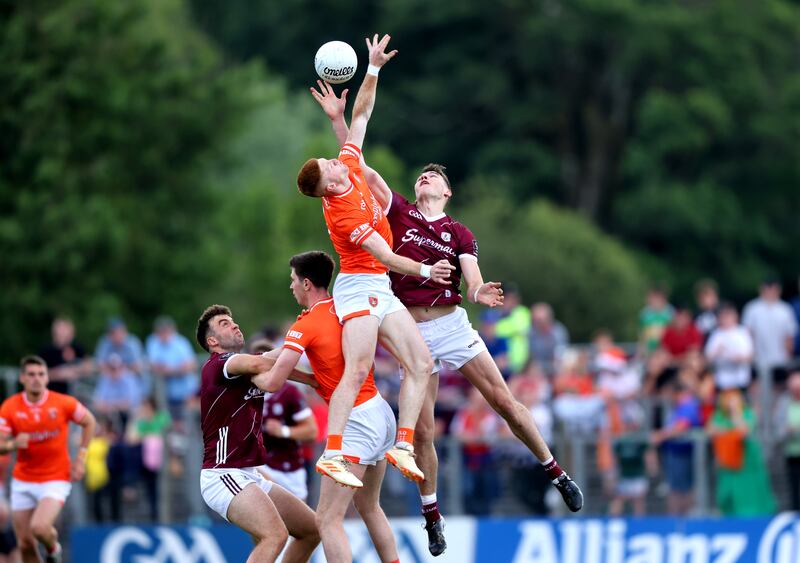 Armagh's Ciaran Mackin and Matthew Tierney of Galway challenge for the ball. Photograph: Tom Maher/Inpho