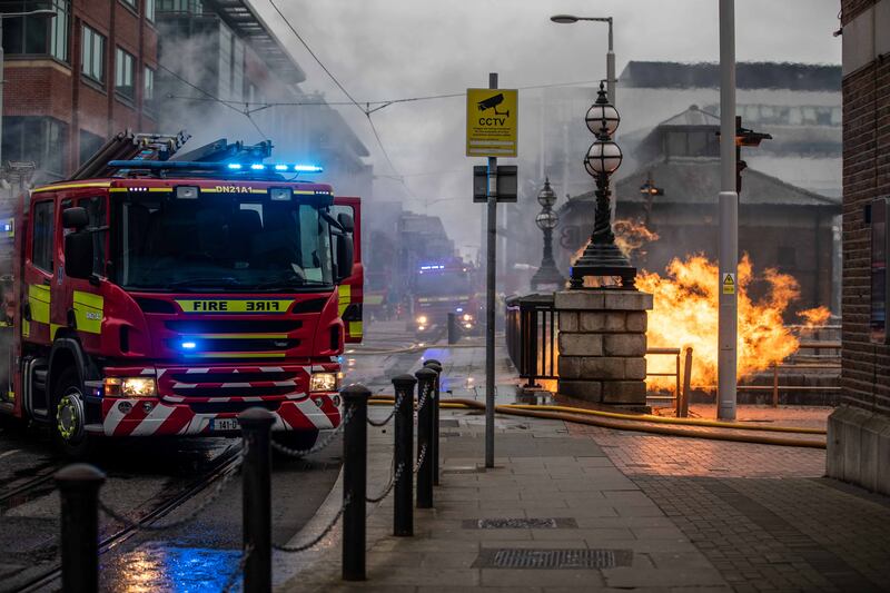 Dublin Fire brigade members battle a fire near the IFSC on Tuesday evening. Photograph: Damien Storan