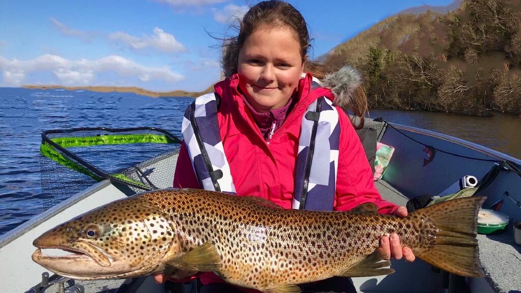 Nichola Ward with her specimen ferox trout of 14lb 8oz caught on Lough Corrib with father and guided by Tomi Kurman of Corrib Predator Team.