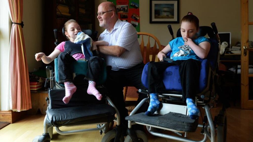 Damien Douglas at home with his daughters Una (left) and Ailis. Photograph: Cyril Byrne
