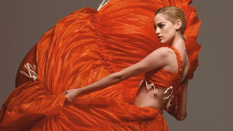 The parachute dress.
Norma Kamali updated the parachute dress in International Orange in 1974, replacing silk with waterproof nylon with an inherent ability to catch the wind.