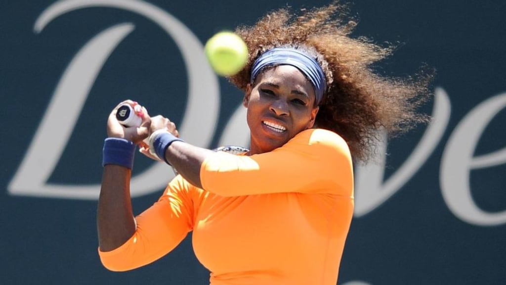 Serena Williams hits a backhand shot during a semifinal match against her sister Venus Williams at the Family Circle Cup tennis tournament in Charleston, S.C., Saturday, April 6, 2013. Serena won 6-1, 6-2. (AP Photo/Stephen Morton)