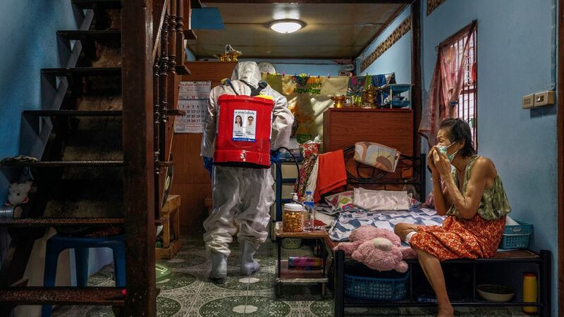 Disinfectant is sprayed in the living area of a person who tested positive for Covid-19 in Klong Toey, the largest slum in Bangkok. Photograph: Adam Dean/The New York Times
